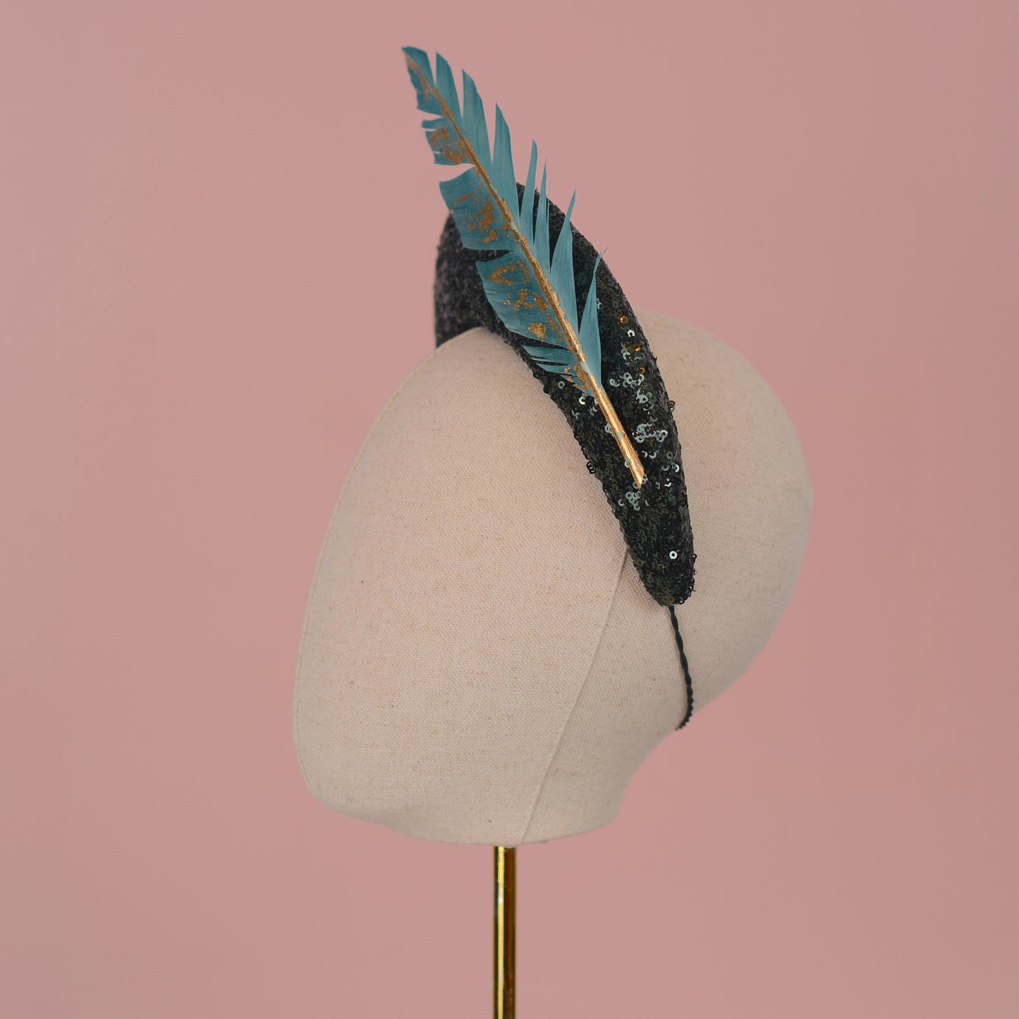 Sequin Bandeau Headband with Floating Gold Leaf Feather on a Deep Green