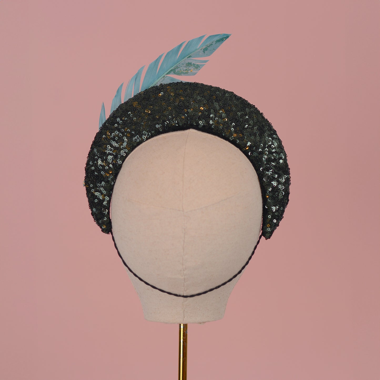 Sequin Bandeau Headband with Floating Gold Leaf Feather on a Deep Green