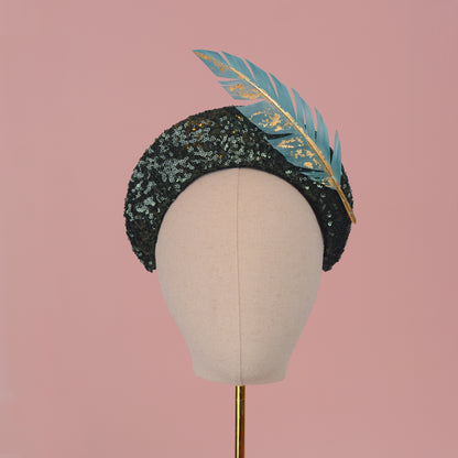 Sequin Bandeau Headband with Floating Gold Leaf Feather on a Deep Green