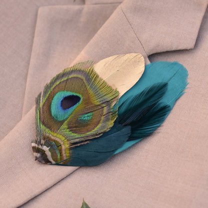 Gold and Teal Peacock feather brooch on a beige blazer