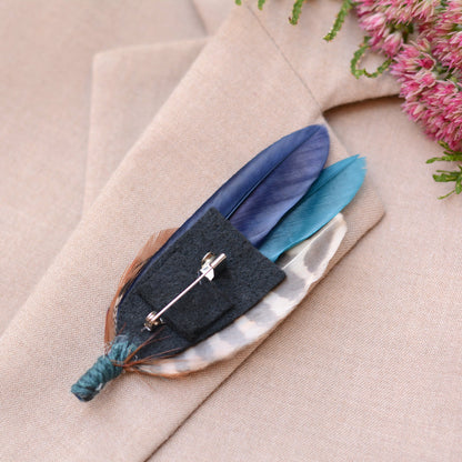 Feathered boutonniere on a beige coat with pink flowers in the background