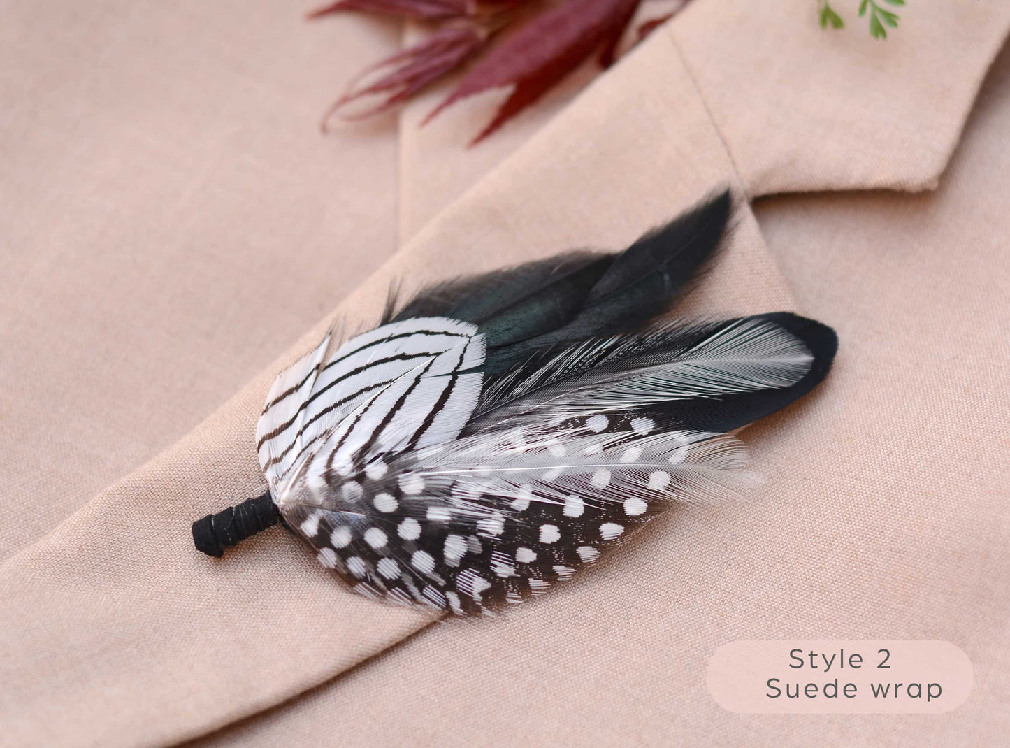 Black and white Feathered boutonniere on a beige coat with 'Style 2 Suede wrap' text.