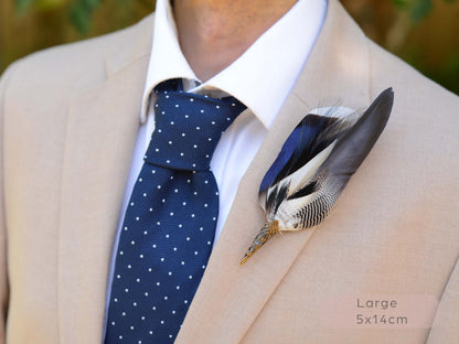 A close-up of a beige suit jacket worn with a white dress shirt and a navy polka-dot tie, featuring a decorative feather boutonniere on the chest. The text 'Large 5x14cm' is visible in the bottom right corner.