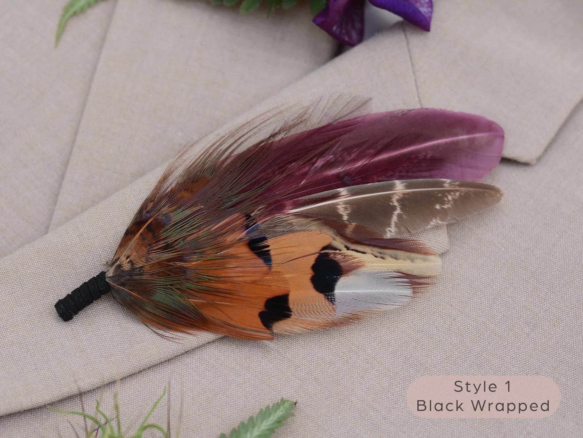 Large feather boutonniere brooch in purple, burgundy and copper pheasant feathers with black chord wrapped stem.