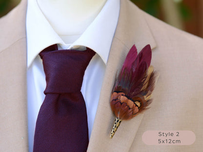 Burgundy and pheasant Feather lapel pin buttonhole on a suit jacket with a purple tie