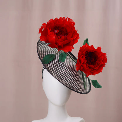 Black checkered hat with red flowers on a mannequin head against a beige background
