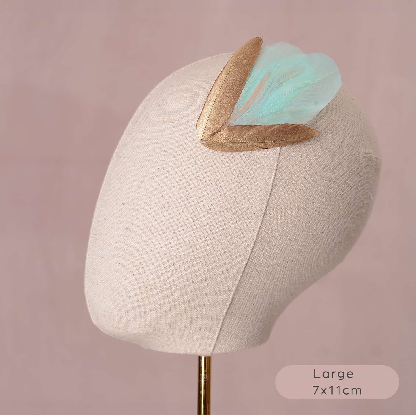 Large mint green and gold feather hair clip on canvas covered mannequin head