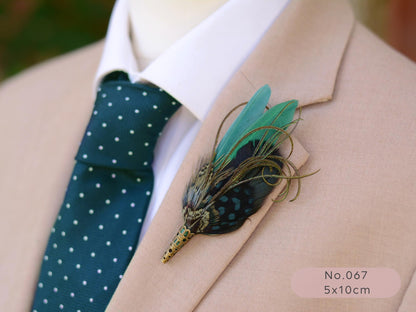 Green feathered boutonniere on a suit lapel with a green tie and beige jacket.