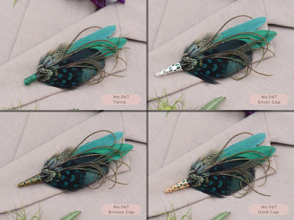 Feathered brooches with green and black feathers on a light beige fabric showing different finishing options of green twine, silver metal cap, gold metal cap, bronze metal cap
