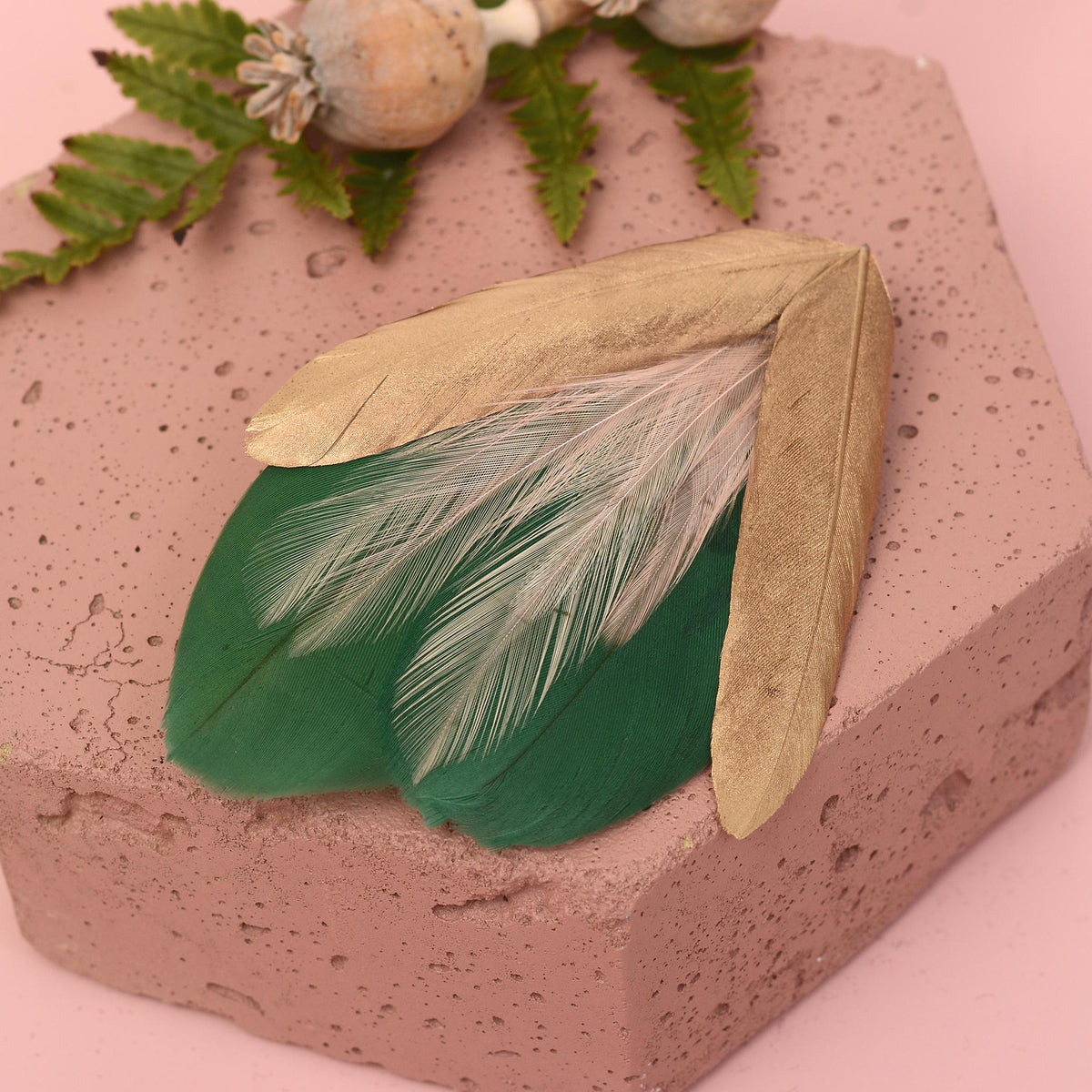Feather hair clip fascinator in green, pale pink and gold.