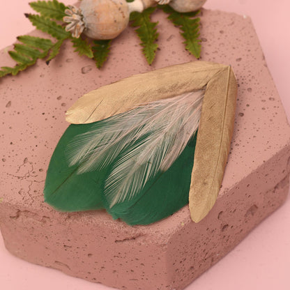 Feather hair clip fascinator in green, pale pink and gold.