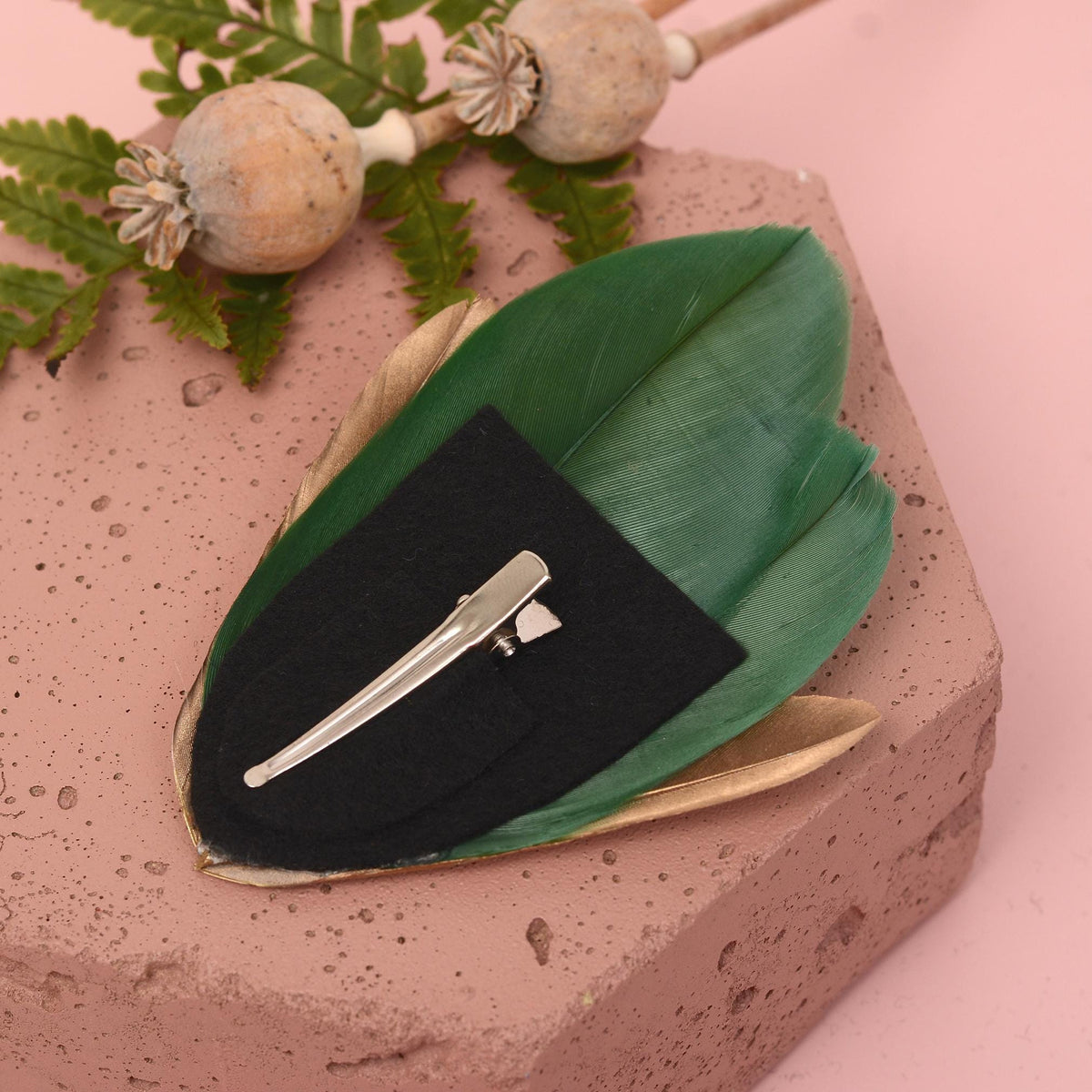 feather hair clip on a back felt base with a silver metal alligator clip