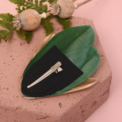 feather hair clip on a back felt base with a silver metal alligator clip