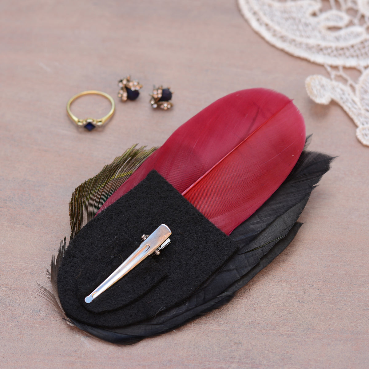 Feather hair clip fascinator shown upside down to show the felt base and silver alligator style clip