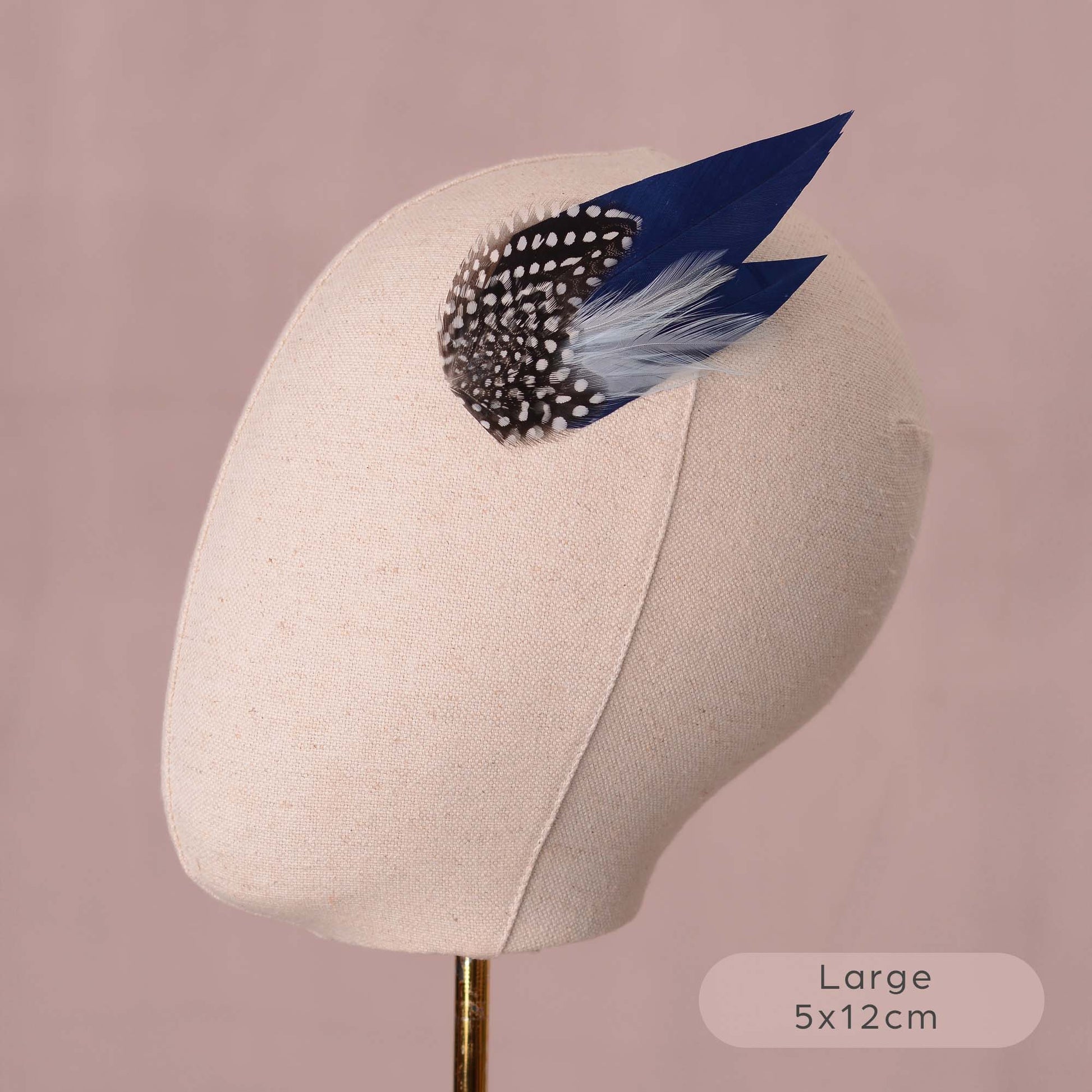 large navy blue feather hair clip on a canvas mannequin head