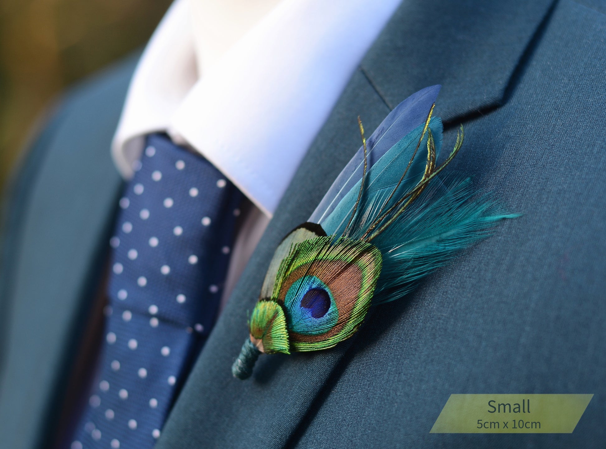 Peacock feather boutonniere on a suit lapel with a blurred background