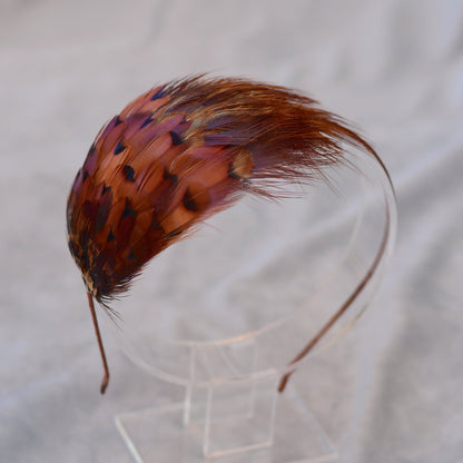 Pheasant feather headpiece. Curved pheasant feathered pad on a narrow headband.