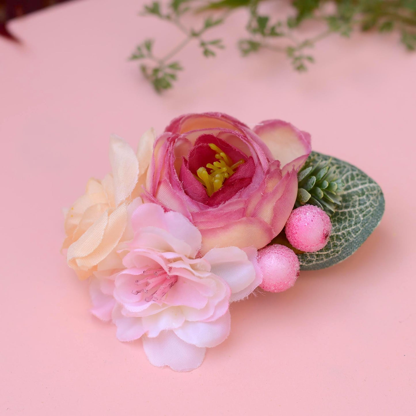 Floral hair accessory with pink and cream flowers  on a pink background