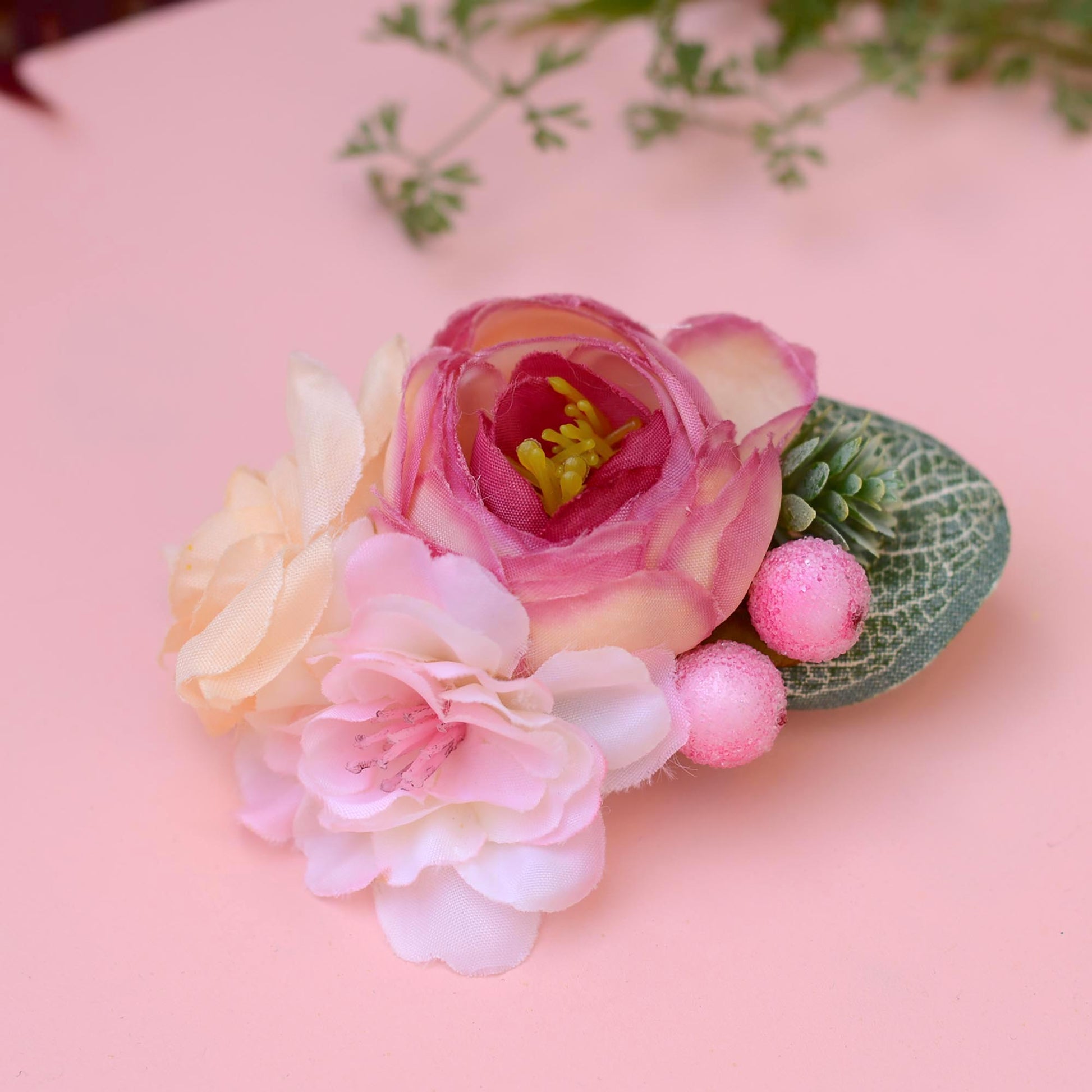 Floral hair accessory with pink and cream flowers  on a pink background