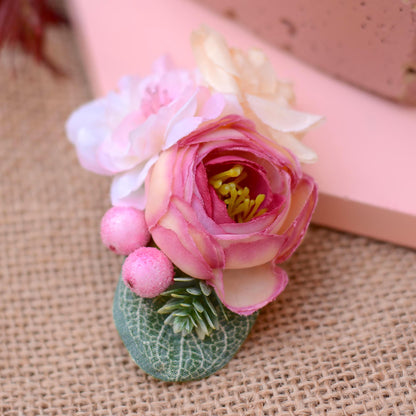Pink flower hair pin on a textured fabric background