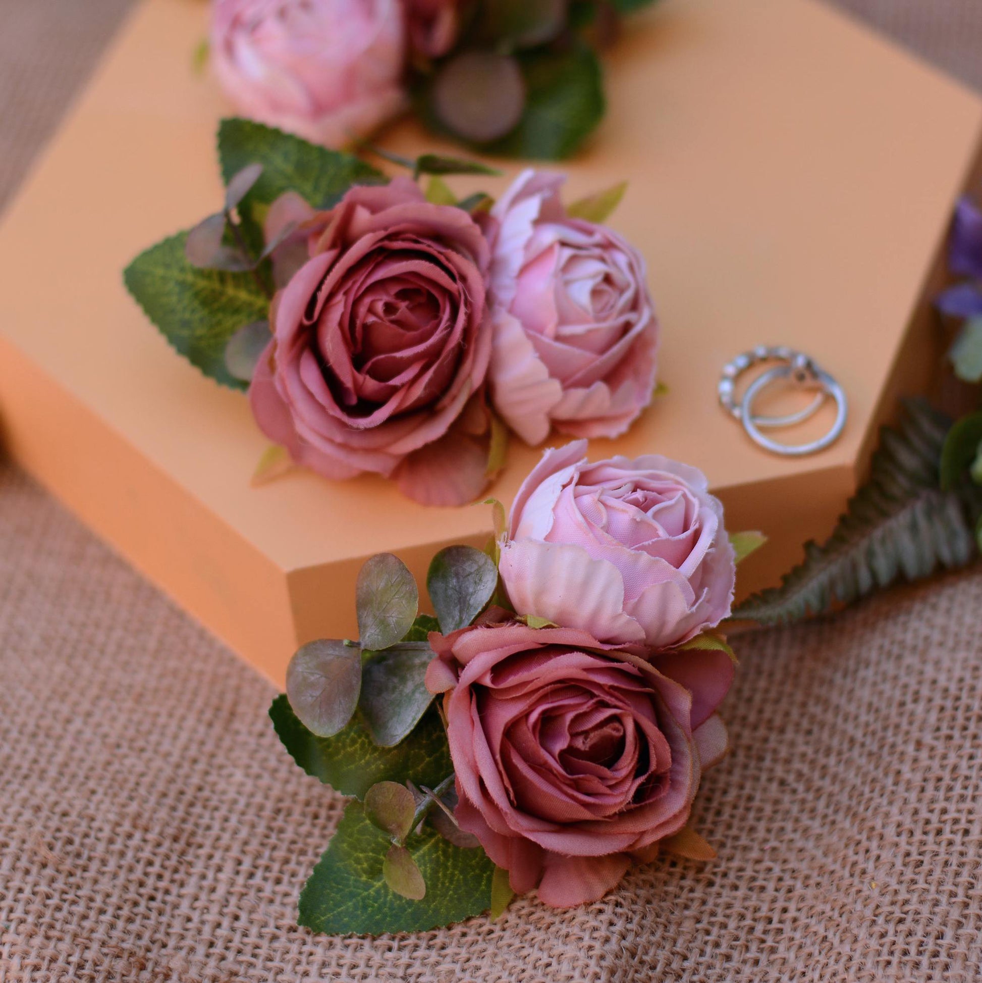 pink rose hair clip accessory on an orange background