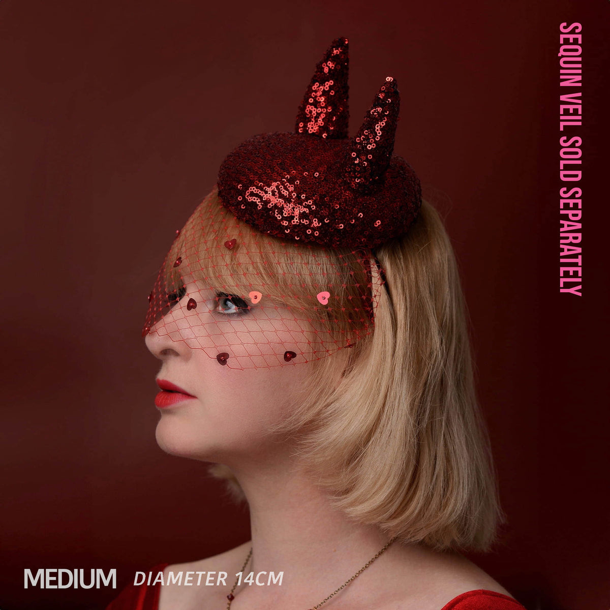 A woman in profile wearing a red sequin devil horn headpiece with a matching red heart-net veil. The image has text overlays reading 'SEQUIN VEIL SOLD SEPARATELY', 'MEDIUM', and 'DIAMETER 14CM' against a dark reddish-brown background.