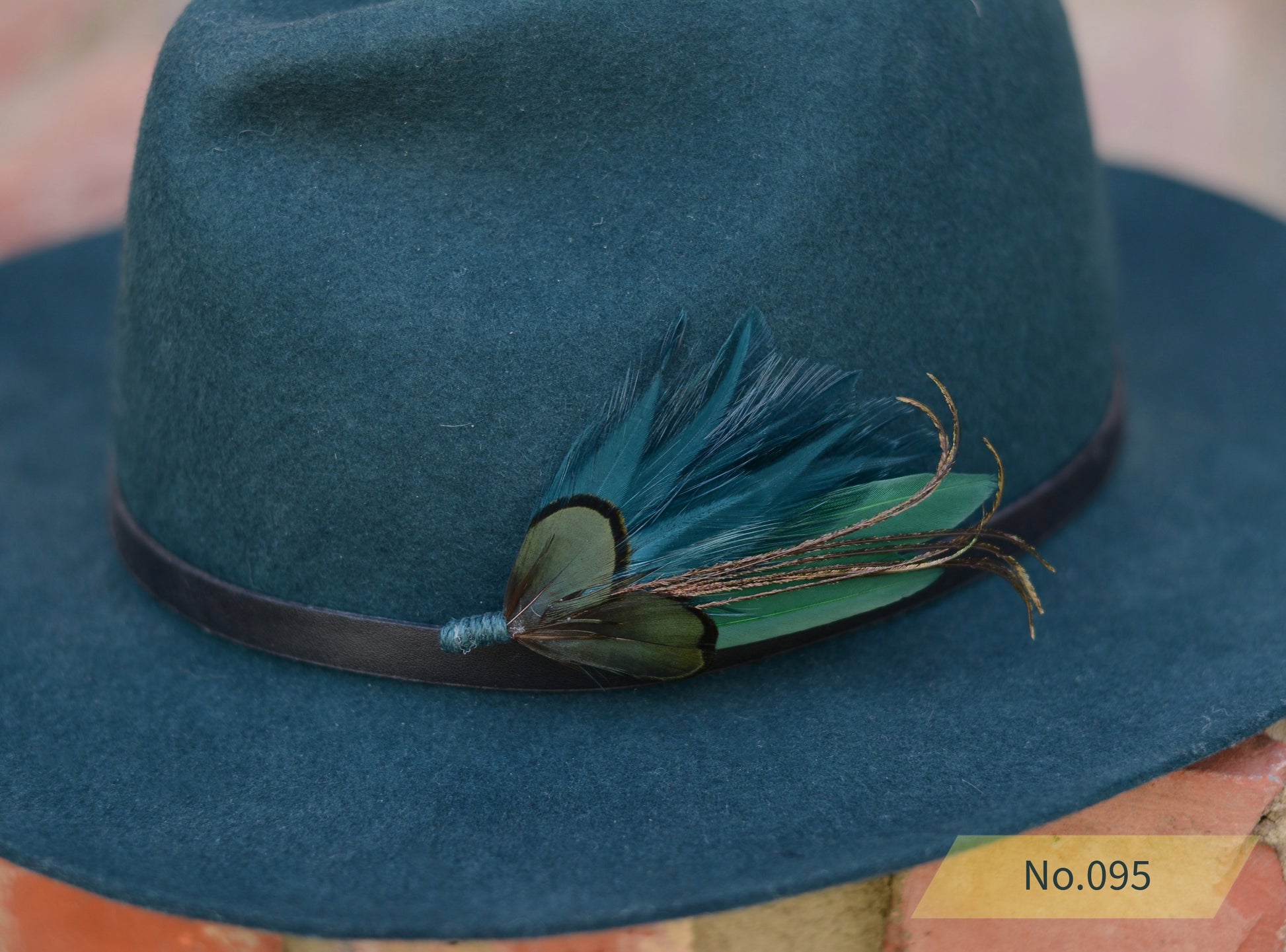 Green fedora hat with green and teal feather hat pin 