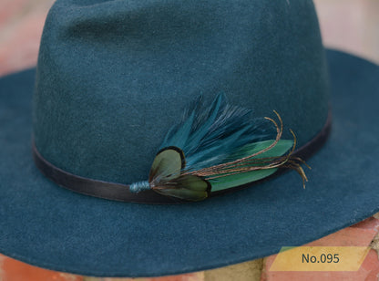 Green fedora hat with green and teal feather hat pin 